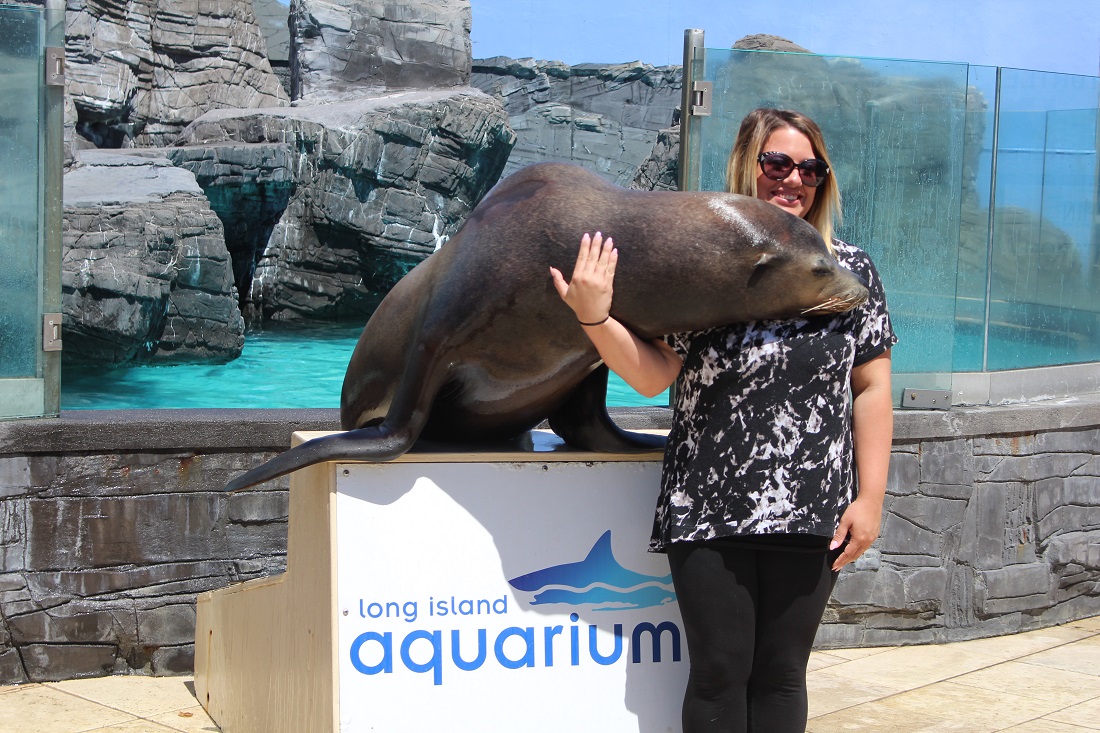 Woman getting a hug by a sea lion
