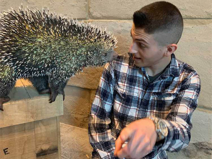 Person posing with porcupine