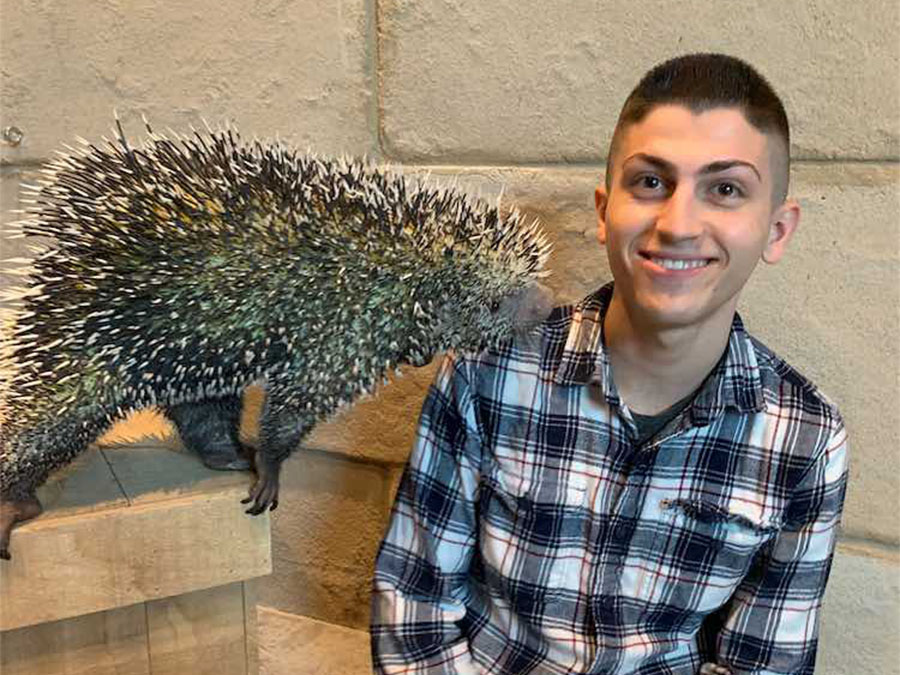 Person posing with porcupine