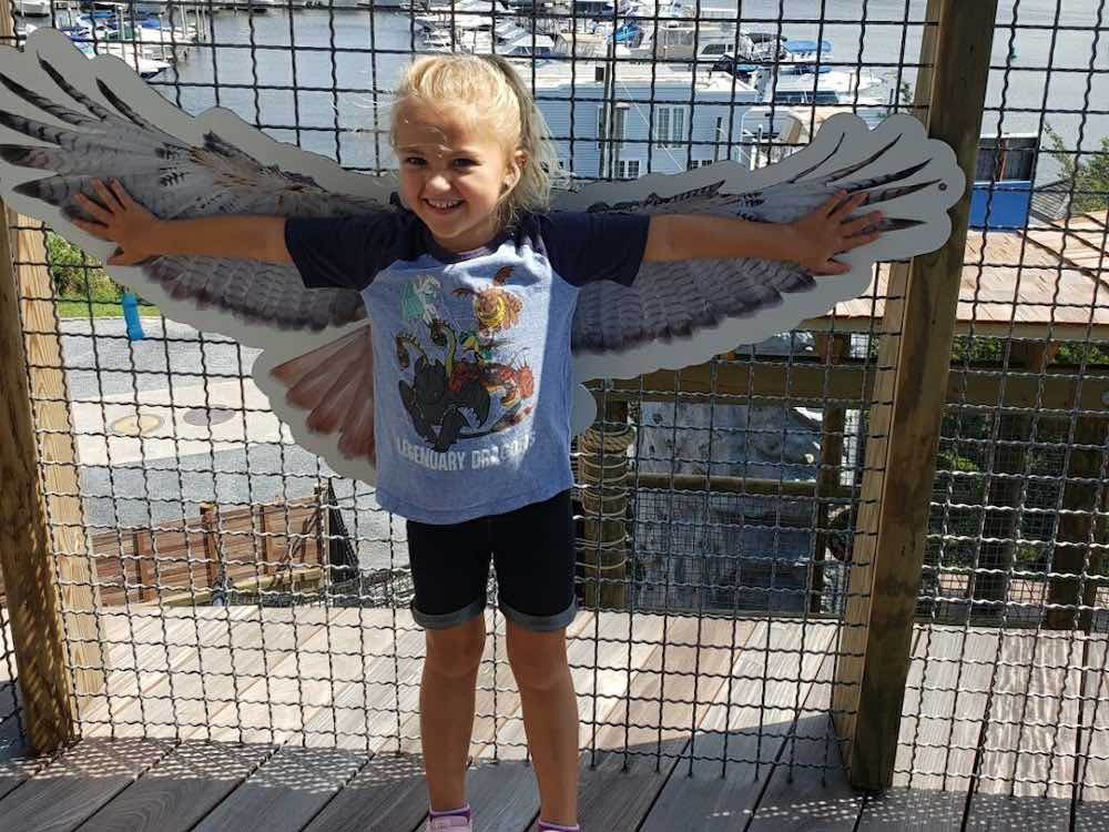 child posing like a bird