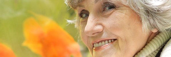 senior lady smile with fish in background