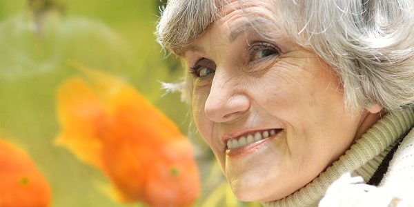 senior lady smile with fish in background