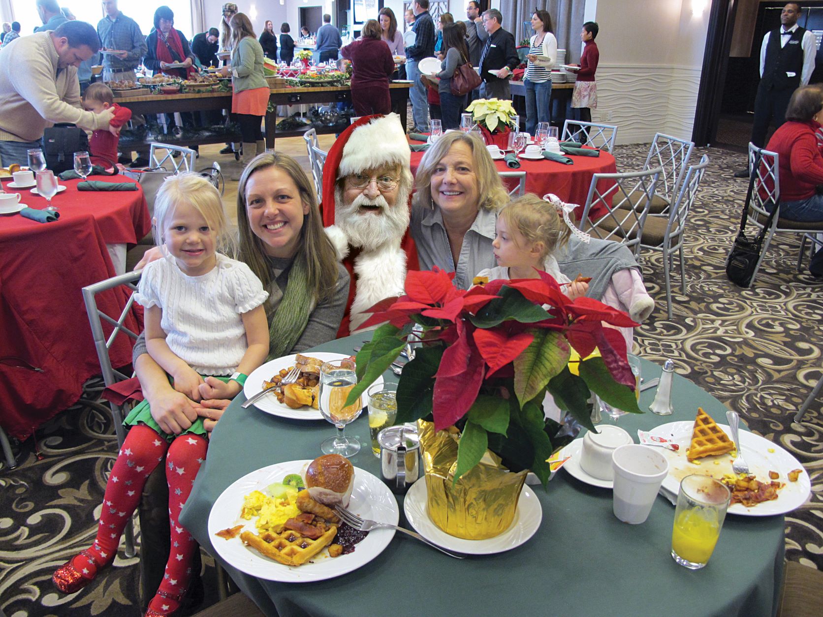 Santa with a family at Santa Brunch